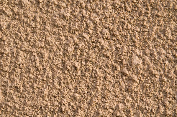 Twardy drobnoziarnisty piasek tło — Zdjęcie stockowe