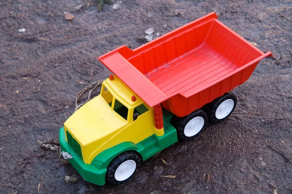 Baby toy dump truck in dirt — Stock Photo, Image