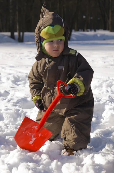 Baby with red shovel — Stock Photo, Image
