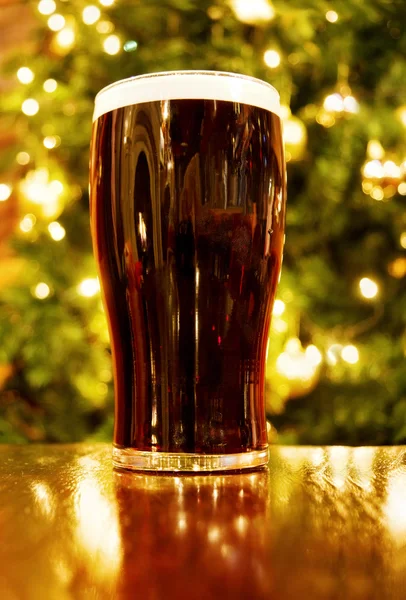 Christmas with Irish pint of black beer — стокове фото