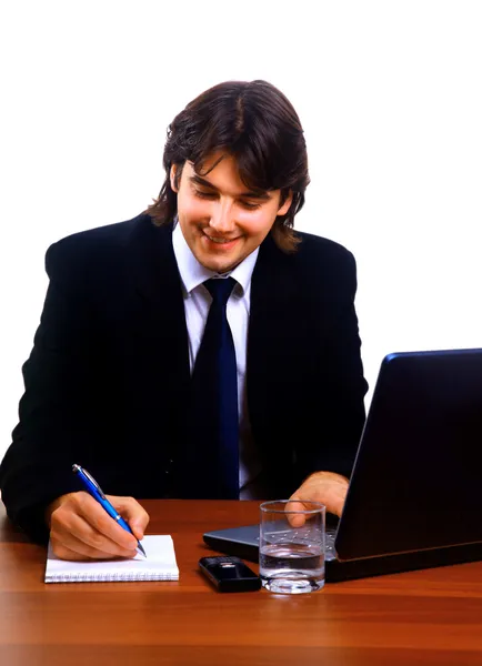 Biznesmen siedząc przy biurku — Zdjęcie stockowe