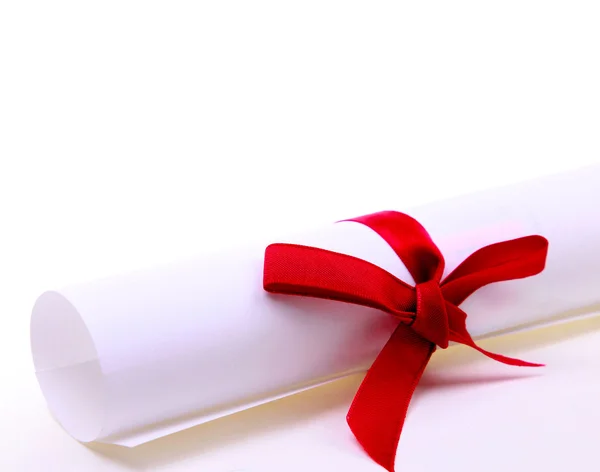 Paper scroll and red bow — Stock Photo, Image