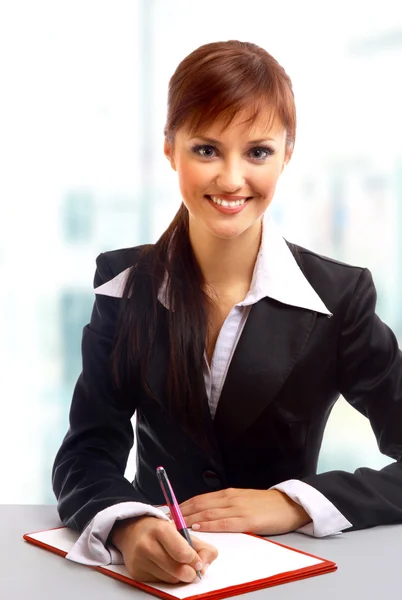 Businesswoman working at desk Stock Image