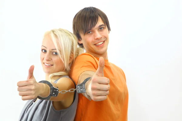 Portrait of a young teenage couple smiling against white background — Stock Photo, Image