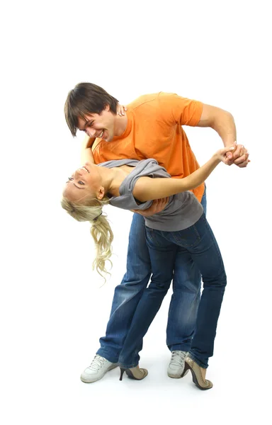Young couple in black attire dancing happily — Stock Photo, Image