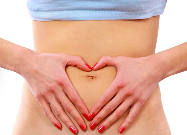 Love - A woman's hands forming a heart symbol on belly — Stock Photo, Image