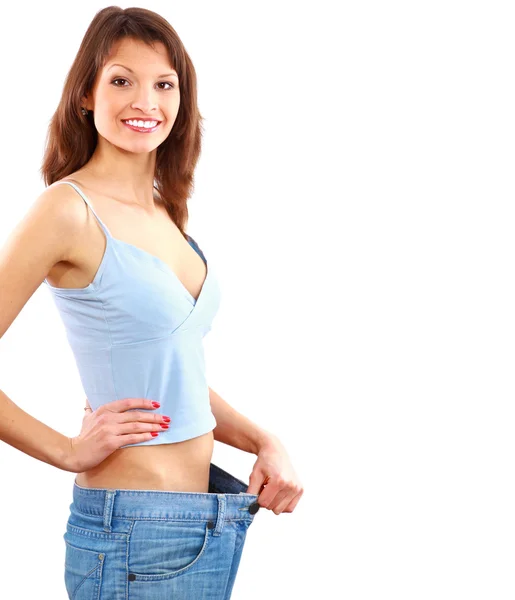 Szczęśliwa młoda kobieta w stare dżinsy spodnie po utracie wagi — Zdjęcie stockowe