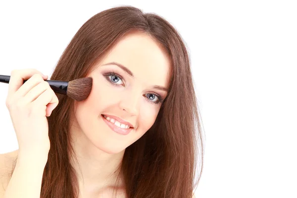 Portrait of attractive young woman applying blusher — Stock Photo, Image
