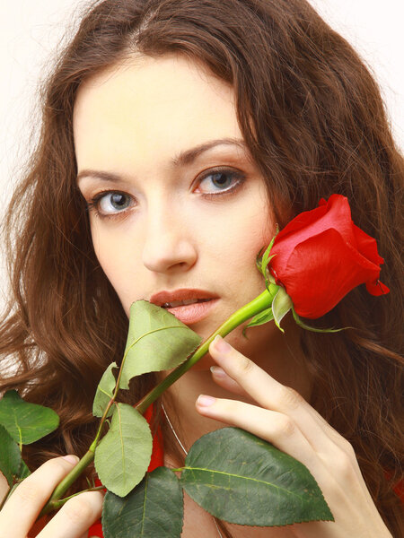 Studio portrait of sensual beautiful woman with rose