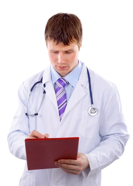 Αρσενικό γιατρός γράφει κάτι στο σημειωματάριο. λευκό φόντο — Φωτογραφία Αρχείου