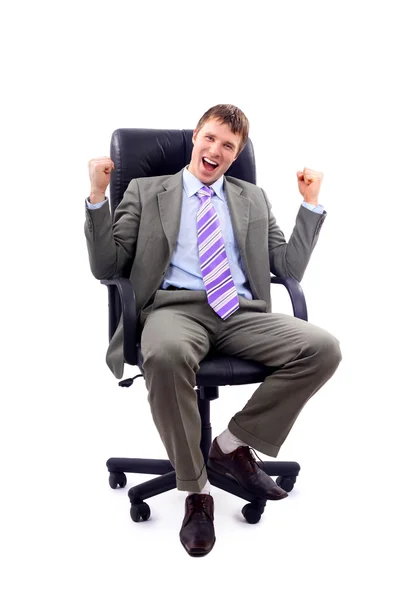 Homem de negócios feliz sentado em uma cadeira — Fotografia de Stock