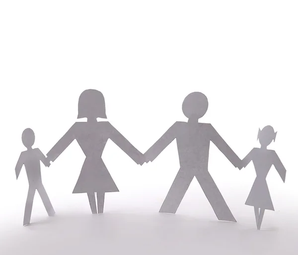 Cutout семья из четырех стоящих держась за руки — стоковое фото