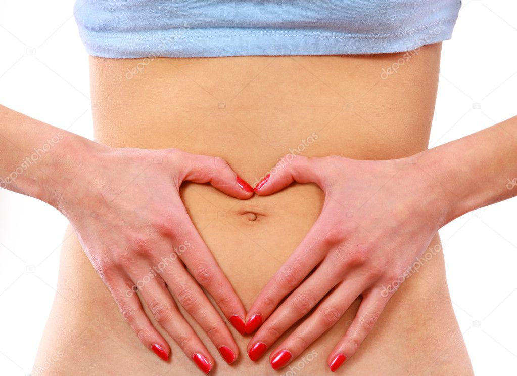 Love - A woman's hands forming a heart symbol on belly