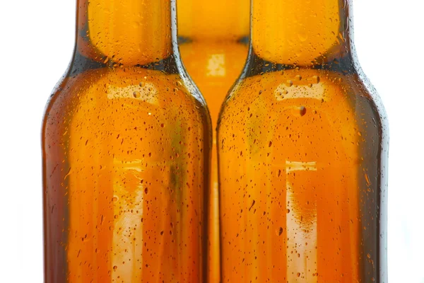 Upper part of three beer bottles — Stock Photo, Image