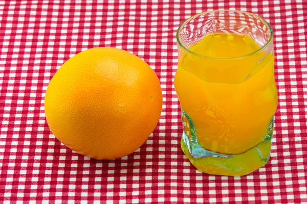 stock image Glass of orange juice and fruit