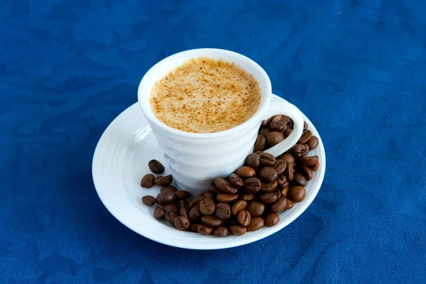 Cup with coffee and grain expressed on b — Stock Photo, Image