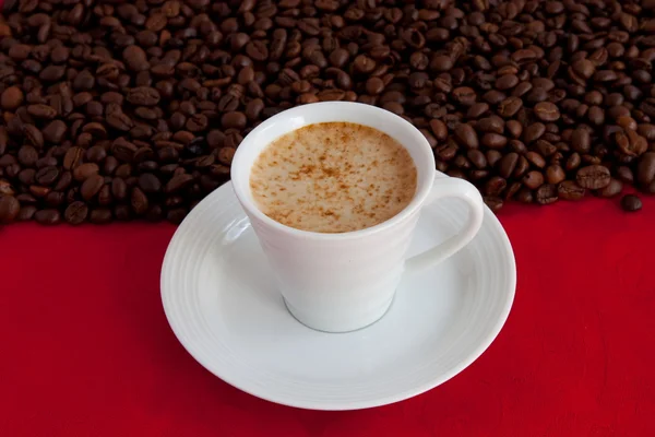 Cup with coffee and grain expressed on r — Stock Photo, Image