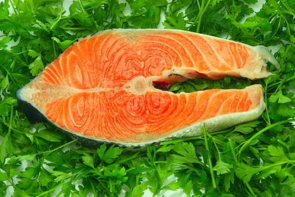 Fresh salmon steak on the salad leaf — Stock Photo, Image