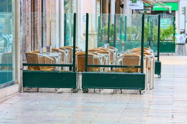 Empty tables in street cafe clipart