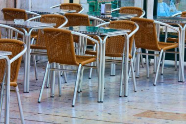 Empty tables in street cafe clipart