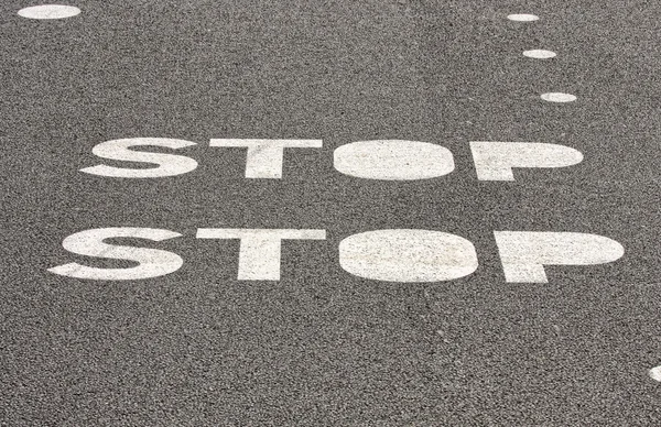 Stop sign on paved road — Stock Photo, Image