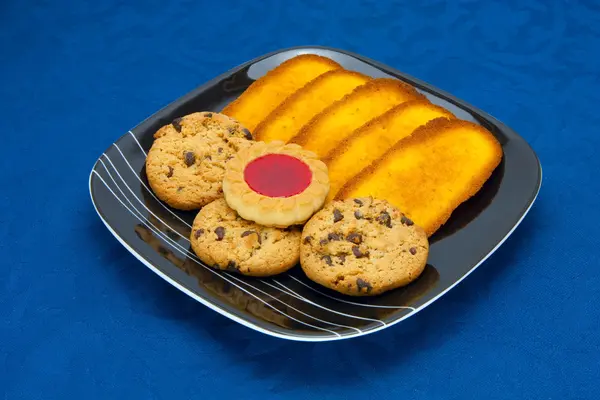 Ciasteczka na płytce na niebieskim tle — Zdjęcie stockowe