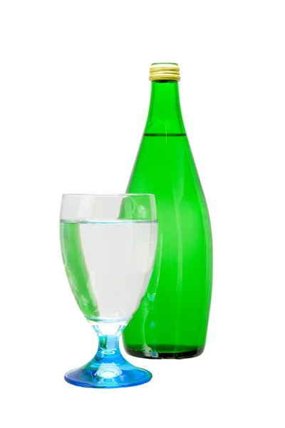 Green bottle and glass of water — Stock Photo, Image