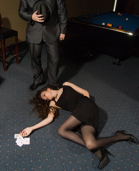 Dead woman with cards and man above her