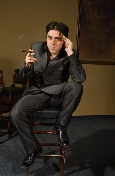 Gangster smokes cigar in retro bar — Stock Photo, Image
