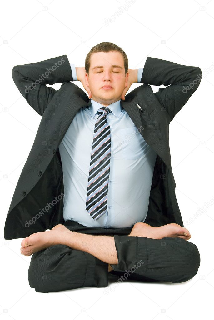 Businessman meditating in yoga style