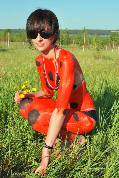 Woman ladybird body art on nature — Stock Photo, Image