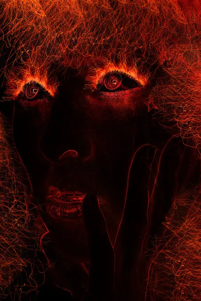 Woman face made of fire