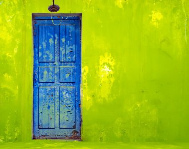 Blue Door in Shabby Green Wall clipart