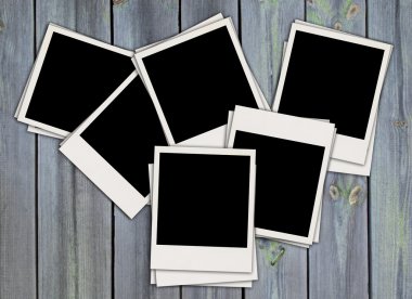 Pile of Blank Photos on Wood Background clipart