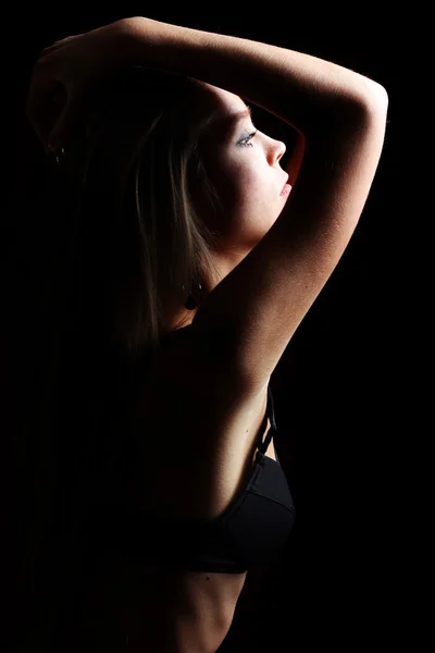 Loira sexy em lingerie preta sobre escuro — Fotografia de Stock