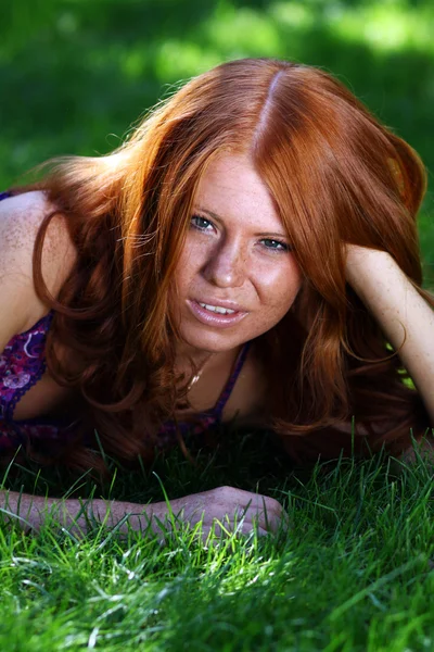 Red-haired girl in summer park — Stock Photo, Image