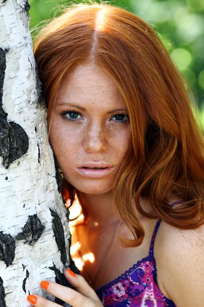 Red-haired girl in summer park — Stock Photo, Image