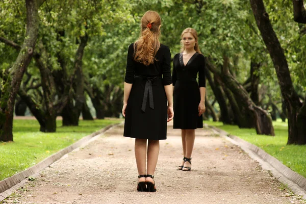 Twins of sister in black dress — Stock Photo, Image