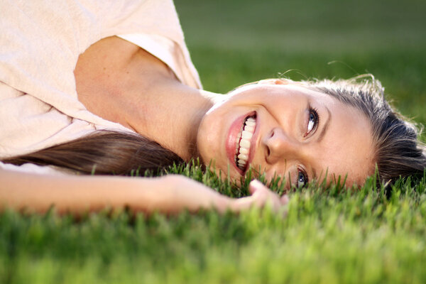 Woman lying on grass field at the park