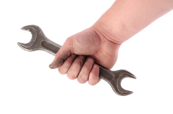 Een metalen moersleutel is in een hand — Stockfoto