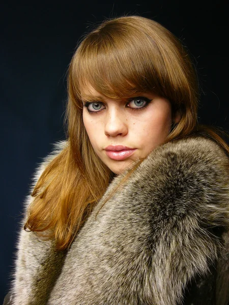 Very beautiful girl in a fur coat — Stock Photo, Image