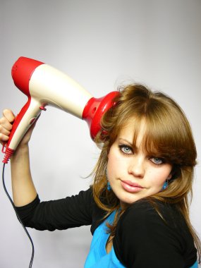 Woman dries hair the hair dryer clipart