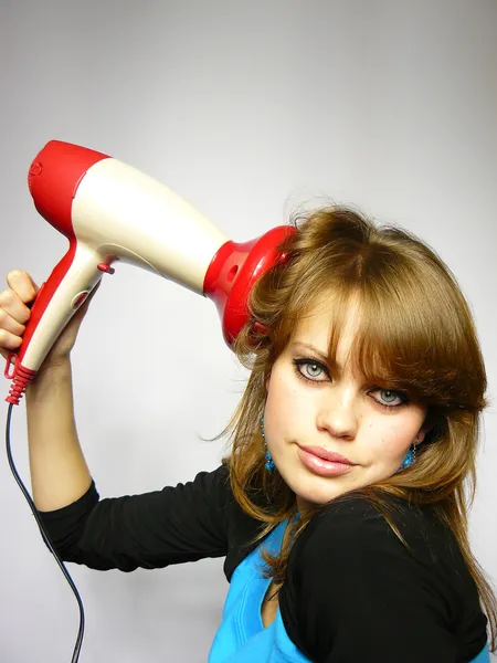 Woman dries hair the hair dryer — Stock Photo, Image