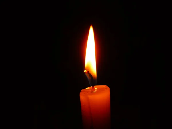 Stock image Candle burning in the dark