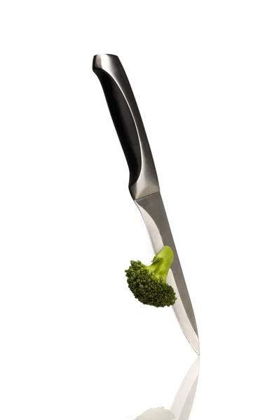 Cutting broccoli isolated — Stock Photo, Image