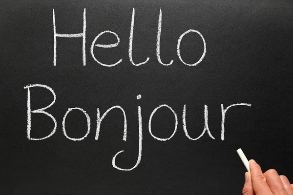 Bonjour, Hej på franska på en svart tavla — Stockfoto