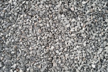 Lots of large gray stone chippings. clipart