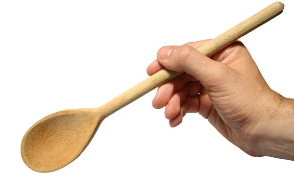 Holding an old wooden spoon. — Stock Photo, Image