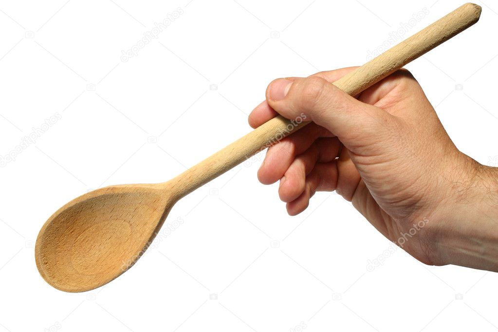 Holding an old wooden spoon.