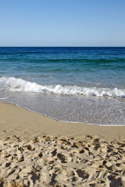 Waves reaching Porthcurno beach. clipart